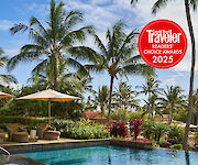 A tropical pool scene with lounge chairs, umbrellas, palm trees, and a red “Travelers Choice Awards 2025” badge.